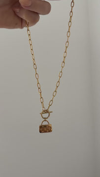 Silent product video of the Petite Maison necklace showing the charm, chain and toggle clasp